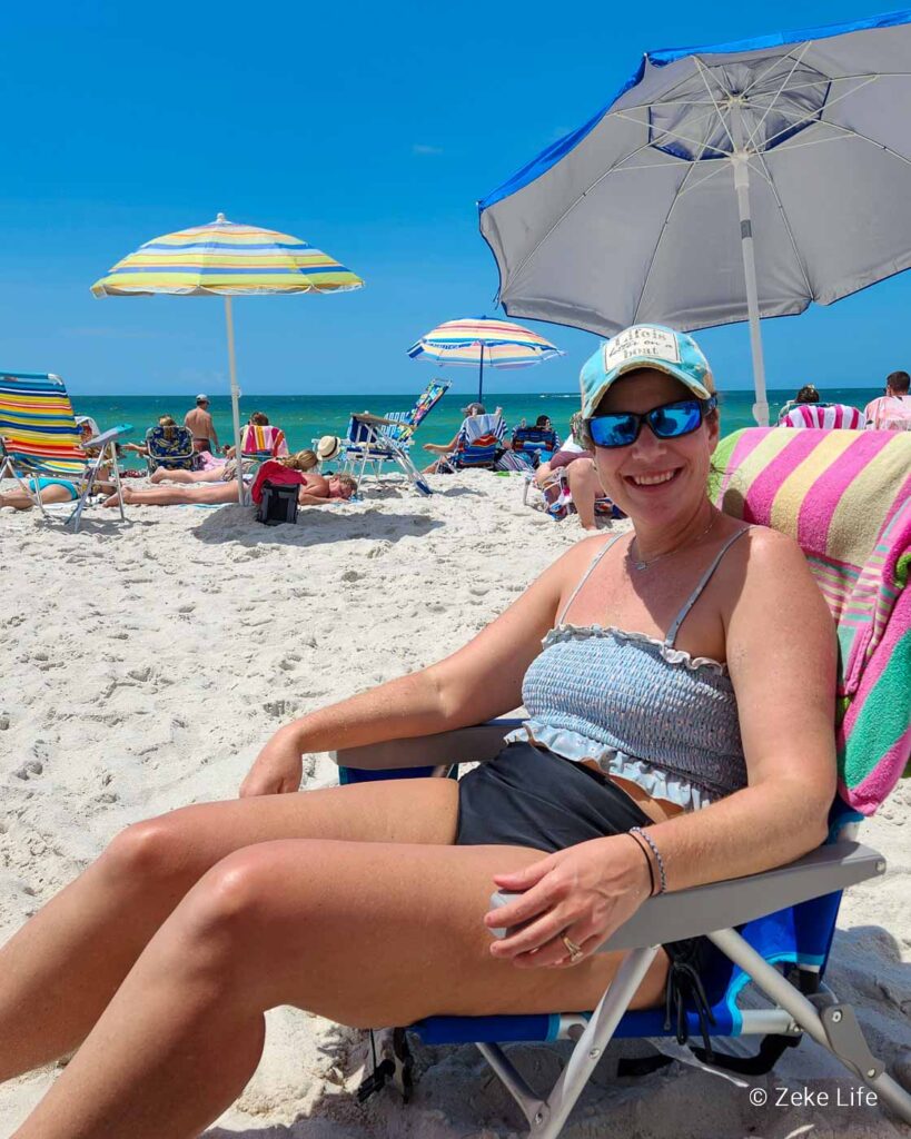 kara sitting in chair at beach