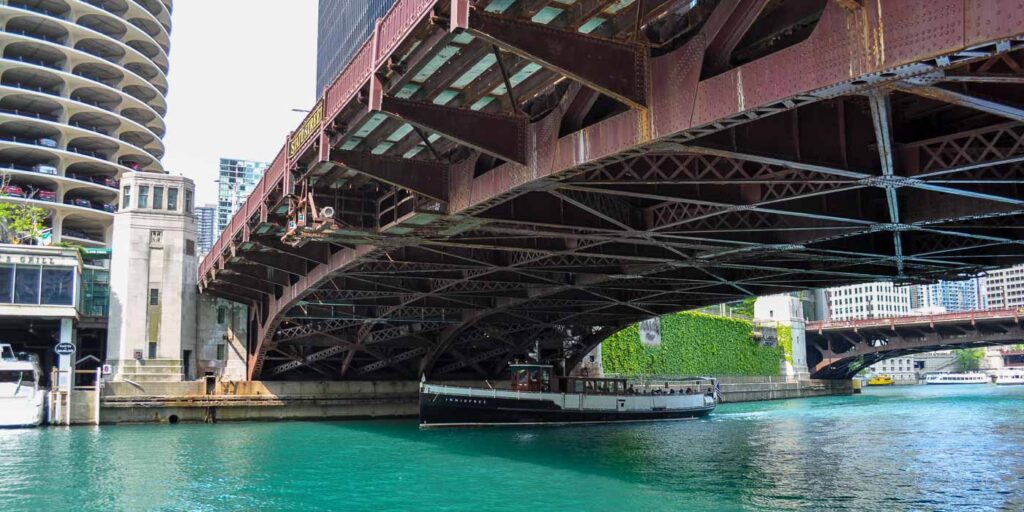 boat crossing under the State Street Bridge in Chicago