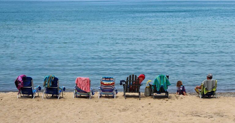 beach chairs sitting out in front of Lake Michigan