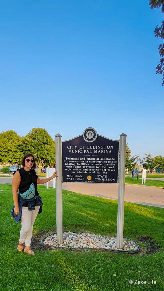 Kara standing next to Ludington sign